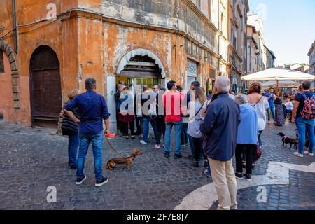 Streets of Rome, people lined up in front of Pasticceria il Boccione, Kosher bakery, pastry shop, Jewish Quarter, Rome, Italy. Stock Photo