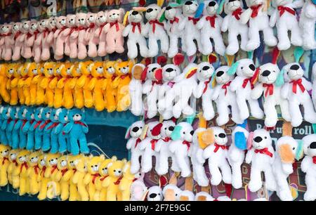 Plush toys and teddy bears hanging up as prizes at a carnival or fairground Stock Photo