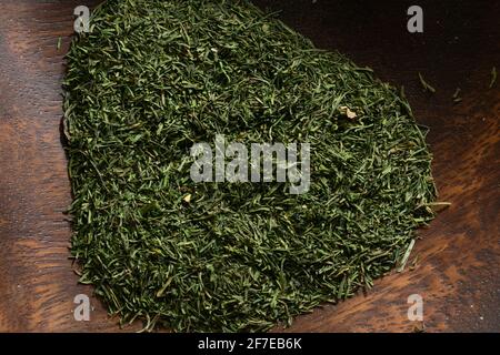Dill weed in a wooden bowl. Stock Photo