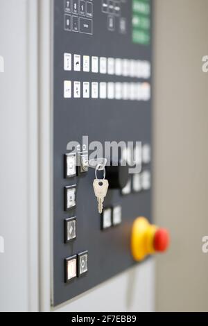 Key switch on a control panel of industrial machine. Selective focus. Stock Photo