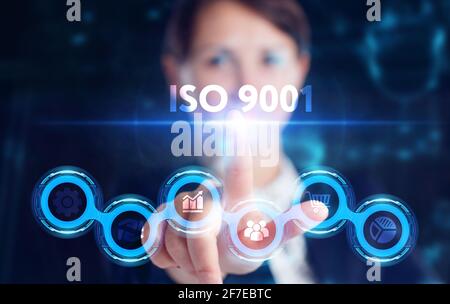 Business, Technology, Internet and network concept. Young businessman working on a virtual screen of the future and sees the inscription: ISO 9001 Stock Photo