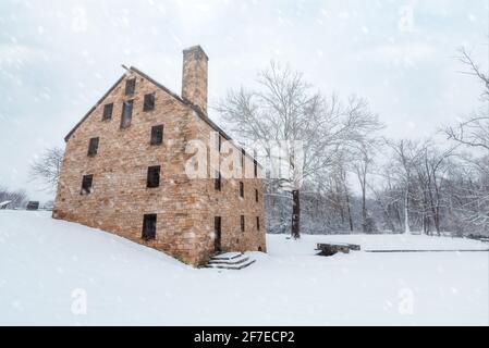 The historical replica of George Washington's Grist Mill in Mount Vernon, Virginia during a winter snow storm in 2019. Stock Photo