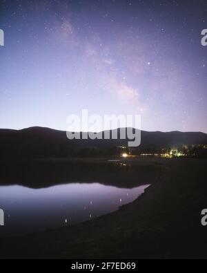 The Milky Way fades into the morning light at dawn approaches in the Shenandoah Valley. Stock Photo