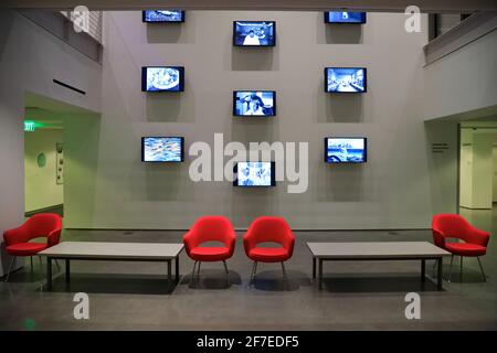 video installation art displaying with red chairs in Fogg Museum.Harvard Museum.Cambridge.Massachusetts.USA Stock Photo