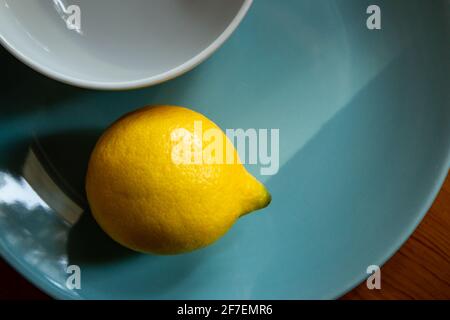 Yellow lemon on the blue plate Stock Photo