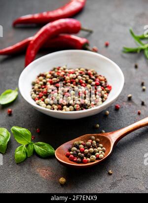 Red hot chili pepper corns and pods on dark  background, top view Stock Photo