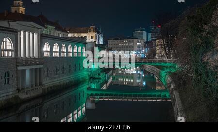 Night panorama of Plecnik arcades in the centre of ljubljana on a beautiful night. Bridges in the background. Stock Photo