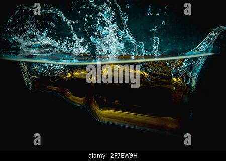 https://l450v.alamy.com/450v/2f7ew9h/brown-beer-bottle-falls-into-water-making-big-splash-of-drops-and-spray-on-a-dark-background-juicy-and-fresh-concept-of-refreshing-drink-in-water-2f7ew9h.jpg