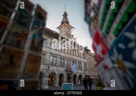 Lausanne City hall with clock tower in early afternoon, looking through the swiss vintage postcards in the foreground. Stock Photo