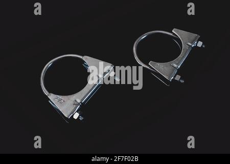 Two exhaust hose clamps isolated on black. Stock Photo