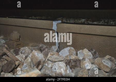 Broken or cracked rail or railway track due to cold temperatures at night. View of a cracked rail track, just next to a welded joint. Cracking of rail Stock Photo