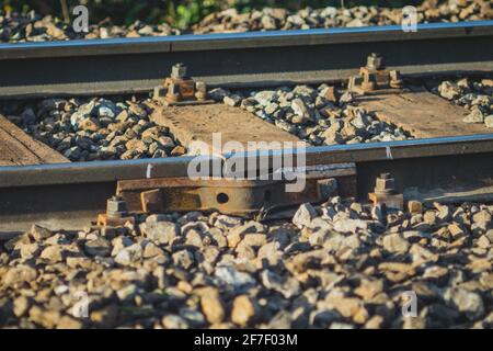 Temporary fix of broken or cracked rail or railway track due to cold temperatures. View of a cracked rail track with a metal plate screwed and welded Stock Photo