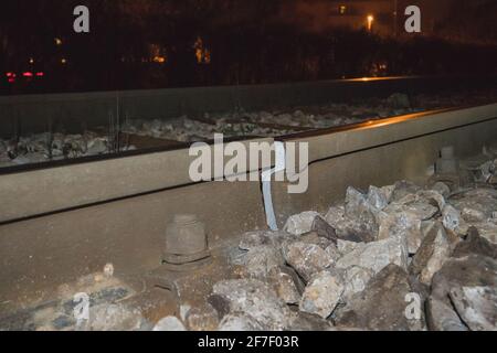 Broken or cracked rail or railway track due to cold temperatures at night. View of a cracked rail track, just next to a welded joint. Cracking of rail Stock Photo