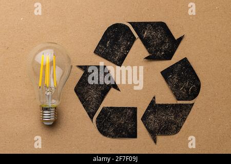 LED light bulb with recycle symbol on craft paper Stock Photo