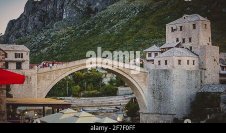 Panoramic photo of Mostar stone bridge in an evening atmosphere. Stock Photo