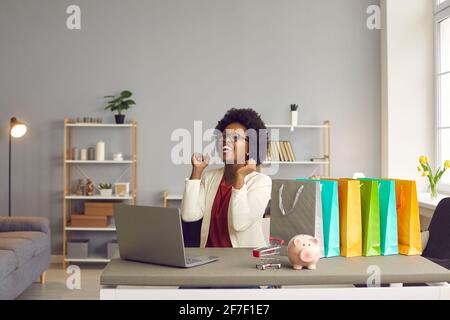 Happy excited woman sincerely rejoices that she has just made a successful purchase online. Stock Photo
