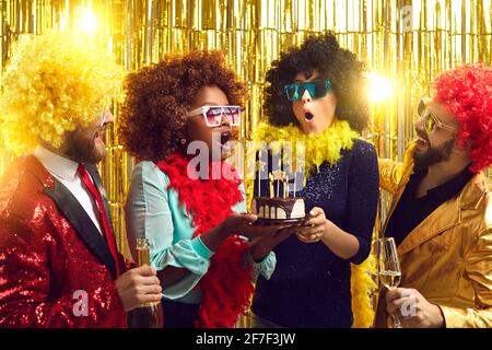 Cheerful multi-racial friends with champagne having fun at birthday party Stock Photo