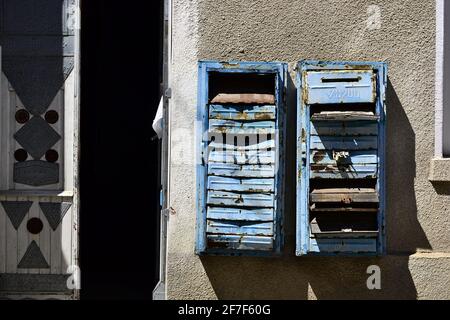 Old rusty mail boxes on the wall. Obsolete broken mailboxes. Stock Photo