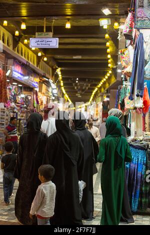 Women in hijabs in the vibrant souq in Mutrah, Oman. Stock Photo