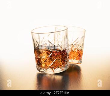 alcoholic drink, whiskey in glasses on brown wooden background Stock Photo