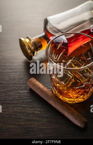 alcoholic drink, whiskey and cigar on brown wooden background Stock Photo