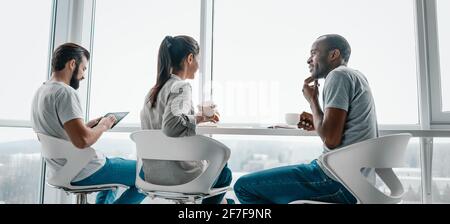 Website header of Multi-cultural colleagues are joking during coffee break at workplace Stock Photo