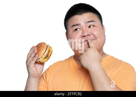 Young man eating burger Stock Photo