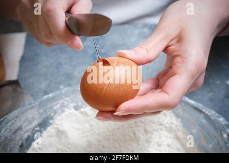 Fresh chicken egg, knife and wheat flour Stock Photo