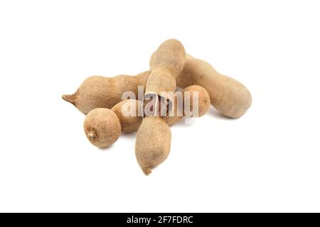 Tamarind fruit (indian date) isolated on white background. Group of tamarind pods. Heap of tropical fruits Stock Photo