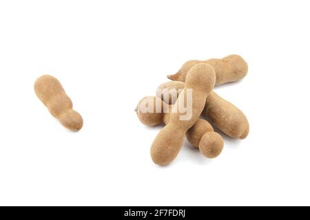 Tamarind fruit isolated on white background. Group of tamarind pods. Heap of tropical fruits Stock Photo