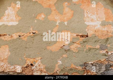 Old plastered wall with cracked paint. Background, texture. Stock Photo