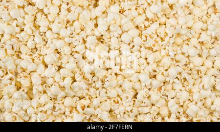Scattered salted popcorn background macro shot Stock Photo