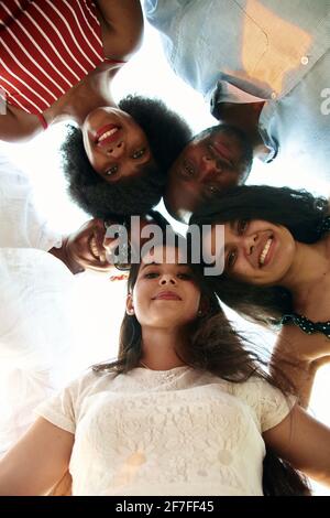Multi-ethnic people look down and smile. The concept of friendship of different peoples. Stock Photo