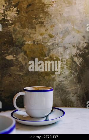 Cup of coffee over the grunge stone wall Stock Photo