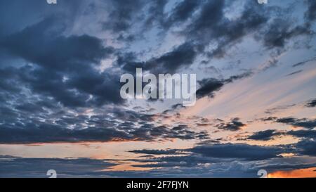 A stormy sky. Colorful image of dramatic cloudscape. Amazing cloud colors before sunset. Stock Photo