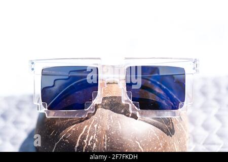 Blue lenses pixel sunglasses model shoot in a summer day closeup. Selective focus Stock Photo