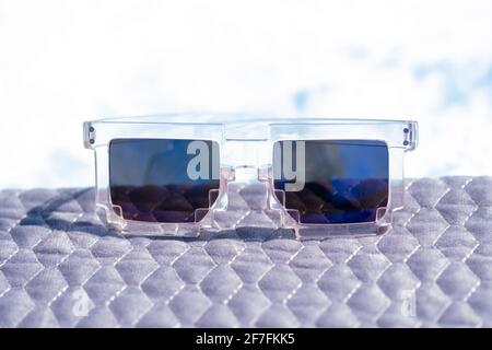 Blue lenses pixel sunglasses model shoot in a summer day closeup. Selective focus Stock Photo