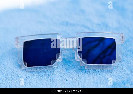 Blue lenses pixel sunglasses model shoot in a summer day closeup. Selective focus Stock Photo