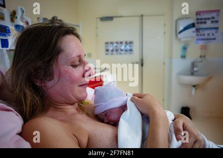 Woman hold newborn baby after giving birth Stock Photo
