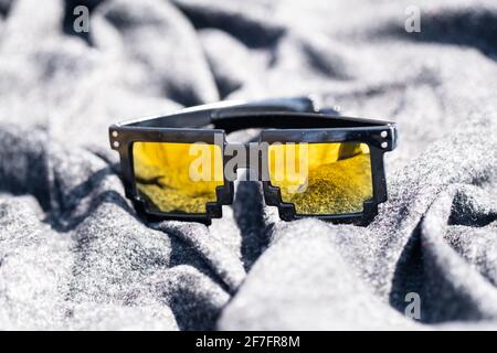 Yellow lenses pixel 8bit sunglasses design shoot in a summer day closeup.Thug life model. Selective focus Stock Photo