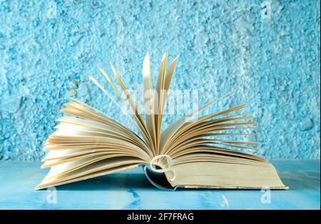 open book on blue background. Reading,literature,education,library,home office, back to school concept,selective focus, good copy space Stock Photo