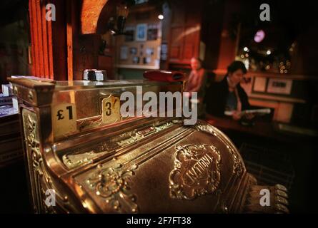 Cash register in the Kings Head pub and theatre December 98  on Upper Street, Islington in London which is determined to use pounds shillings and pence as the way to price beers and spirits, one pound and three shillings buys half pint of lager and thirty bob gets you a whisky Stock Photo