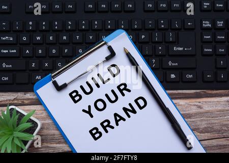 Text a a blue clipboard on top of a black keyboard Stock Photo