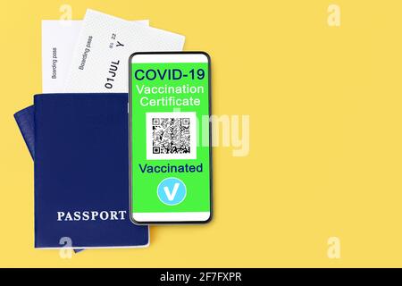 COVID 19 vaccination certificate, smartphone, digital coronavirus immunity health passport, flight boarding pass, vaccinated people travel,  tourism Stock Photo