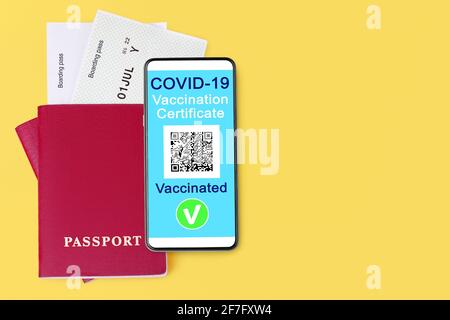 COVID 19 vaccination certificate, smartphone, digital coronavirus immunity health passport, flight boarding pass, vaccinated people travel,  tourism Stock Photo