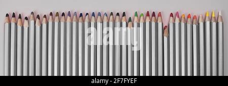 Colored pencils lined up in a row, the theme of creativity and hobby. Stock Photo