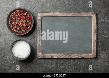 Salt and peppers in bowls Stock Photo