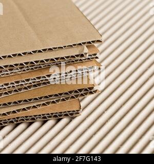 Pile of cardboard pieces on corrugated cardboard Stock Photo