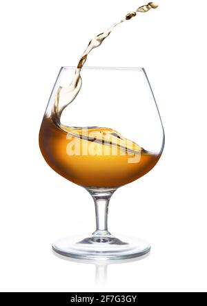 splash of cognac in a snifter isolated on white Stock Photo