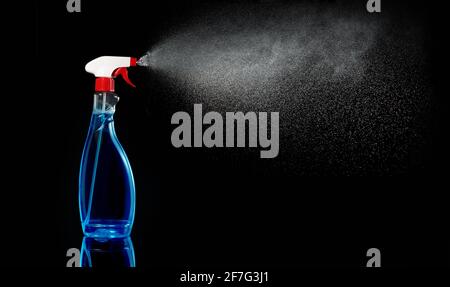 cleanser spraying liquid isolated on black background Stock Photo